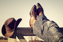 Cowboy Boots And Hat With Feet Up Resting With Legs Crossed