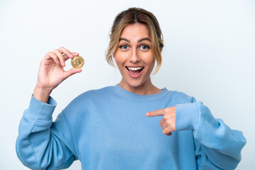 Wall Mural - Young Uruguayan woman holding a Bitcoin isolated on white background with surprise facial expression