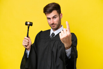 Wall Mural - Judge caucasian man isolated on yellow background doing coming gesture