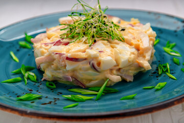 Canvas Print - Egg salad with onions on a bright plate.