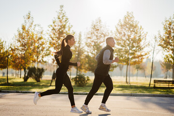  Friends in sportswear running together, outdoors