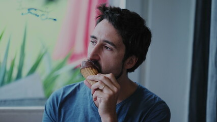 Candid person eating icecream dessert during summer season