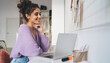 © BullRun - Young millennial woman freelancer work remote at home sitting at table with laptop computer device. Female student learning online with webinar course while using portable netbook for distantly study