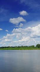 Wall Mural - landscape with clouds over river, timelapse. vertical video
