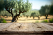 Old wooden table for product display with bokeh background of a natural green olive field. Olive tree layout design with a natural, old tabletop perspective. Generative AI