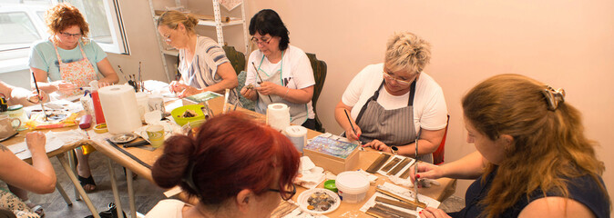 Wall Mural - Women in art workshop making decoupage boxes	