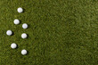 High angle view of white golf balls on grass with copy space