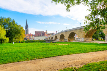 Wall Mural - The old stone bridge over the Danube River with the Saint Peter Cathedral in view in the Bavarian city of Regensburg, Germany.	