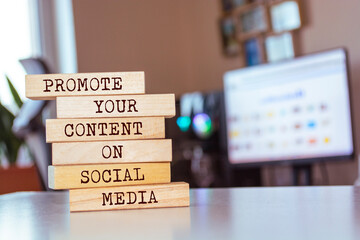 Wall Mural - Wooden blocks with words 'Promote Your Content On Social Media'.