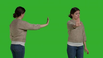 Wall Mural - Close up of negative adult showing rejection gesture with palm, expressing disapproval and refusal symbol. Young person doing stop talking sign with hand, disagreement and reject on green screen.