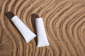 cream tube mockup on wavy sand. top view