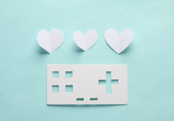 Canvas Print - Paper retro gamepad icon with hearts on blue background. Paper art