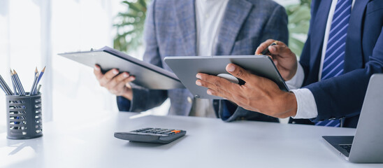 Using tablet pc, Consultant between bookkeepers and accounting lawyer consultation about asset, balance sheet, stock market statistics and yearly tax law, protect business from bribery.