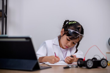 Asian students learn at home by coding robot cars and electronic board cables in STEM, STEAM, mathematics engineering science technology computer code in robotics for kids' concepts.