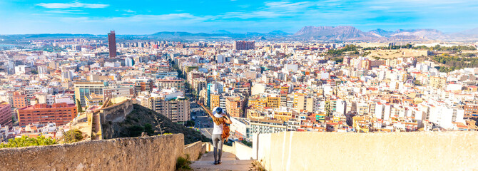 Wall Mural - tourism in alicante- happy woman and backpack enjoying panoramic city view