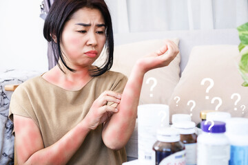 Wall Mural - Asian women scratching on itchy, rash skin caused by allergic reactions to supplements and side effects from too much taking multivitamins