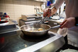 © pavel siamionov - man chef cooking fried shrimp in frying pan on kitchen