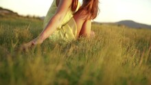 Girl Is Sitting In Grass While Sunset