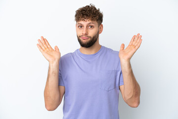 Wall Mural - Young handsome caucasian man isolated on white background making doubts gesture