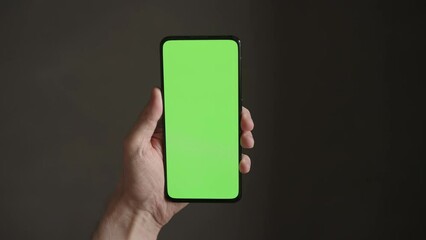 Sticker - POV top view shot of man using phone with green screen indoor