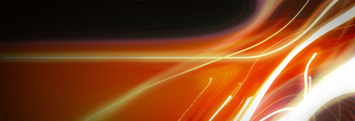 Abstract colorful background with red, white and yellow glowing lines of different thickness and curvature from city lights on a black background. The blur is intentional.