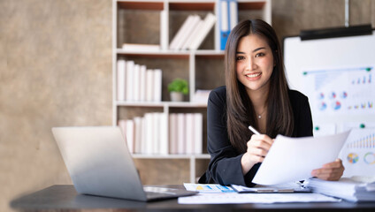 Business woman using calculator for do math finance on wooden desk in office and business working background, tax, accounting, statistics and analytic research concept.