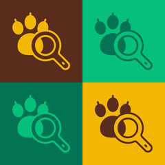 Sticker - Pop art Paw search icon isolated on color background. Magnifying glass with animal footprints. Vector