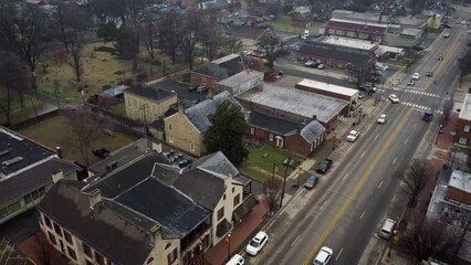 Wall Mural - A drone pulling back above streets in rural Kentucky town to reveal roundabout around old Nelson county courthouse in Bardstown, KY