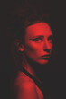 © Rytis - Fashion and make-up concept. Studio portrait of beautiful woman with make-up and long dark dreadlocks hair looking at camera with seductive look. Toned image with red and black color