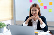 © sabthai - businesswoman sitting and watching laptop screen and smile