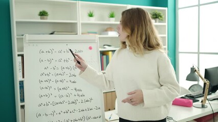 Sticker - Young blonde woman teacher explaining maths exercise at university classroom