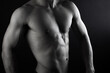 © elsa  - Close up view of sexy body of young man with six pack muscular and athletic body on black background. concept of health care, exercise, fitness, muscle mass, health supplements.