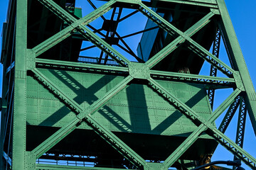 close up of old metal bridge with blue sky