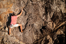 Male Rock Climber Over The Ocean, Free Solo, No Rope, Adventure Sport, Rock Face, Cliff.