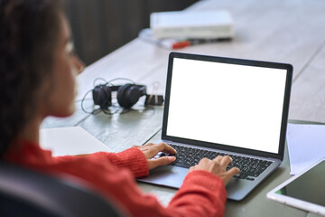 Over shoulder view of woman student elearning looking at white mock up blank screen using laptop computer learning online, remote working, searching on web. Website mockup display template.