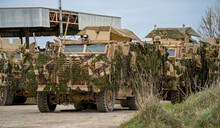Close-up Of A British Army Mastiff Protected Patrols Vehicle Under Green Camouflage Netting