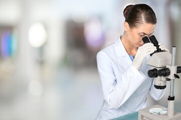 Wall Mural - Scientist person works on microscope in modern laboratory