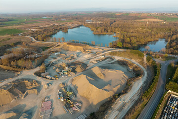 Wall Mural - Aerial view of open pit mining site of limestone materials extraction for construction industry with excavators and dump trucks