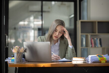 Asian Businesswoman Are Stressed And Tired From Work Sitting At Desk In The Office, Feeling Sick At Work, Stress From Work. 