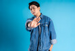  Young asian man posing on a blue background
