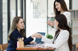 © SOMKID - Group of young Asian business woman teamwork and presenting new projects in the office.