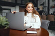 © verona_studio - Woman working on laptop computer ,girl sitting at table studying using laptop, surfing internet