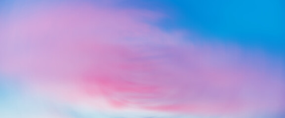 Wall Mural - beautiful backdrop of sunset sky with pink orange light clouds in blue sky. colorful smooth dawn sky