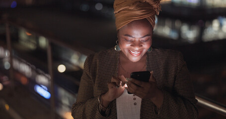 Canvas Print - City, rooftop and black woman on a phone at night networking on social media or the internet. Technology, happiness and African lady browsing online with a cellphone on an outdoor balcony in a town.