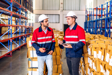 Two engineer team shipping order detail on tablet check goods and supplies on shelves with goods background inventory in factory warehouse.logistic industry and business export