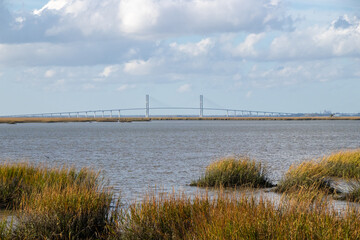 Wall Mural - bridge over a river and cloudy sky