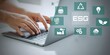 © Abzol - man use computer to analyze ESG, ESG environment social governance investment business concept. ESG icons pop up on the computer screen in business investment strategy concept.