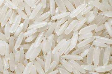 Wall Mural - Rice white raw long-grain, small seeds, background uniform texture, in bulk, close-up, top view