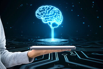 Poster - Close up of hacker hand holding tablet with glowing circuit brain hologram on dark background. AI, machine learning and futuristic technology concept.
