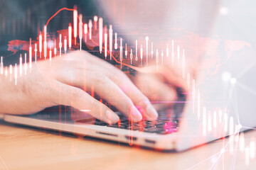 Poster - Close up of hands using laptop computer with glowing falling red forex chart on blurry background. Stock exchange and crisis concept. Double exposure.